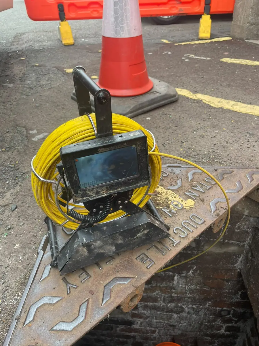 Drain survey camera reel and monitor set up at an inspection chamber